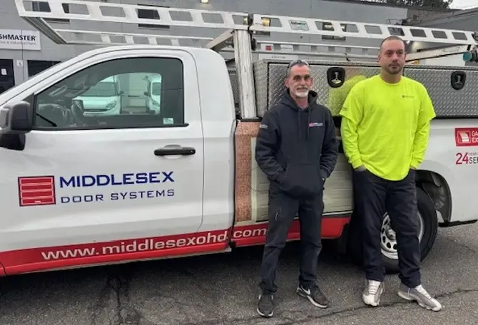 Middlesex Door Systems technicians in front of a truck services